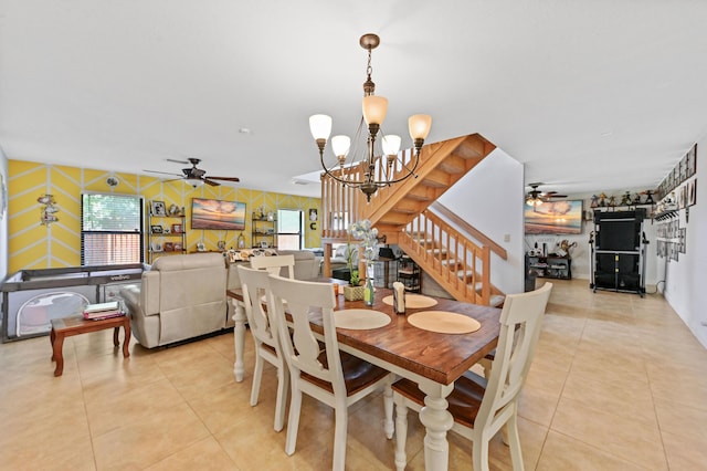 tiled dining room featuring ceiling fan with notable chandelier