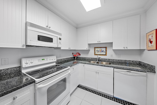 kitchen featuring sink, white appliances, and white cabinets