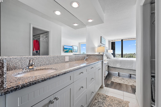 bathroom featuring a textured ceiling, vanity, and tile patterned floors