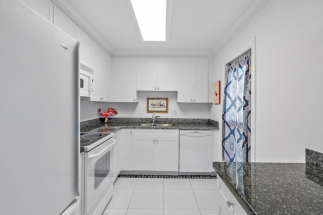 kitchen featuring white appliances, white cabinetry, and sink