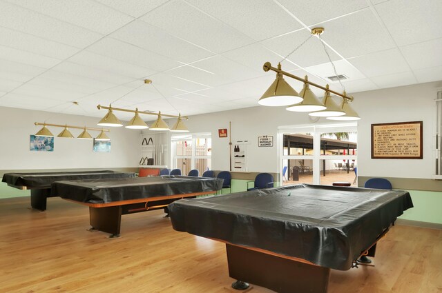 recreation room featuring a paneled ceiling, hardwood / wood-style flooring, and pool table