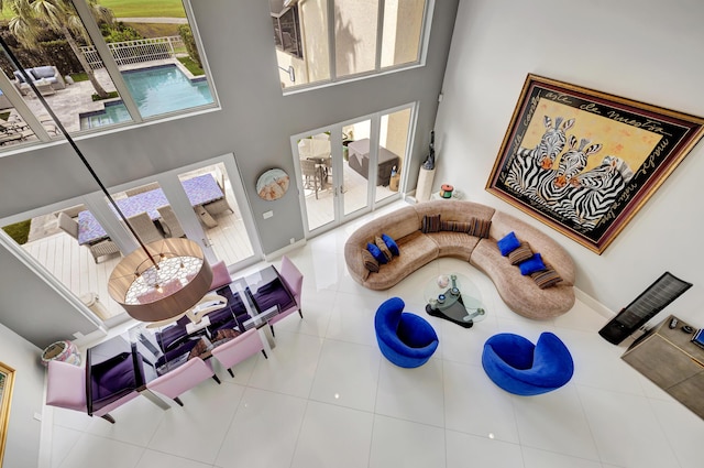 living room with tile patterned floors and a towering ceiling