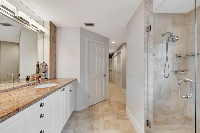 bathroom with vanity and an enclosed shower