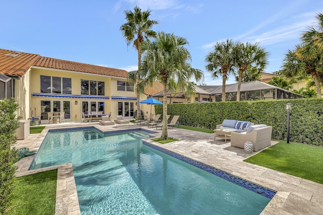 view of swimming pool featuring an outdoor living space, a patio, and french doors