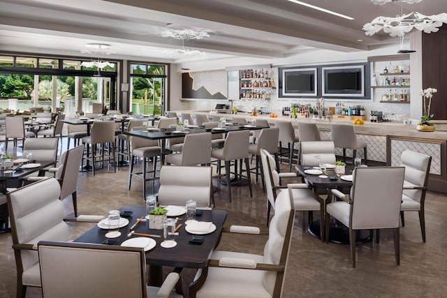 dining space featuring beam ceiling