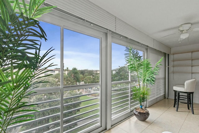 sunroom featuring ceiling fan