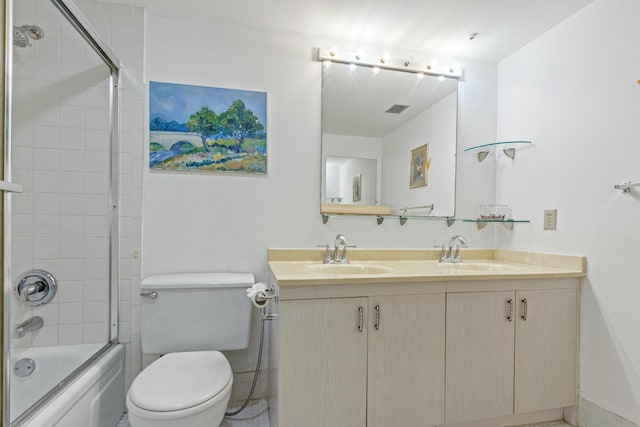 full bathroom featuring vanity, toilet, and enclosed tub / shower combo