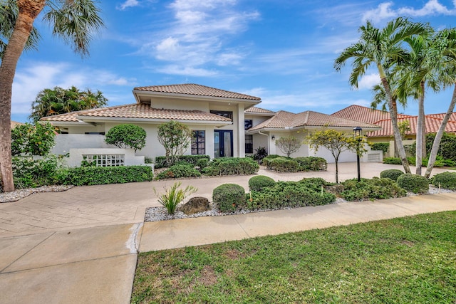 mediterranean / spanish home featuring a garage