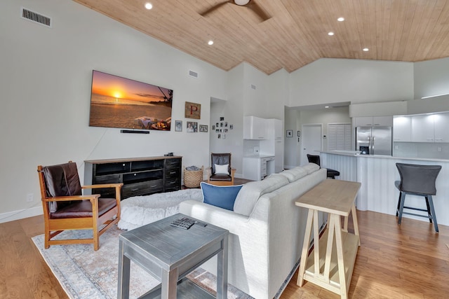 living room with light wood-type flooring, high vaulted ceiling, ceiling fan, and wood ceiling