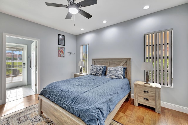 bedroom featuring access to exterior, ceiling fan, and wood-type flooring