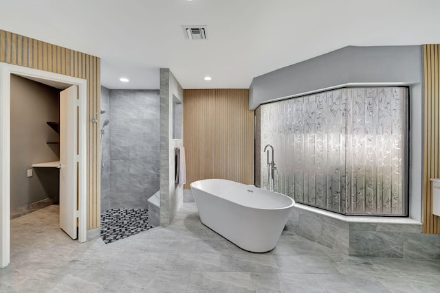 bathroom featuring separate shower and tub