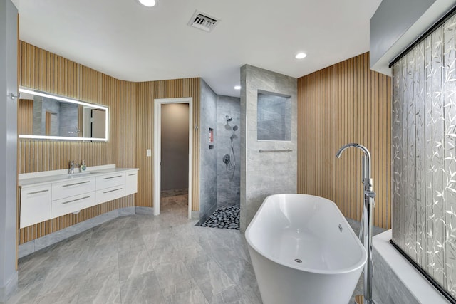 bathroom with vanity and independent shower and bath