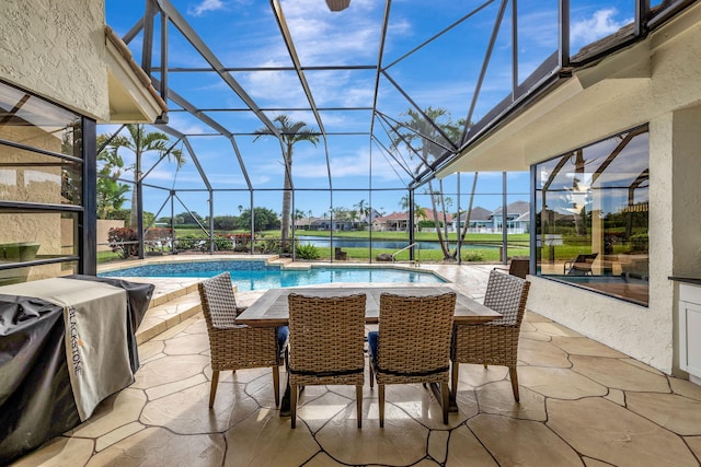 view of pool featuring glass enclosure, a patio, and grilling area