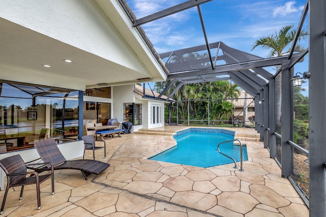 view of pool with glass enclosure, ceiling fan, and a patio area