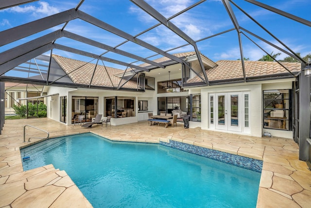 view of pool with a lanai, a patio area, ceiling fan, and french doors