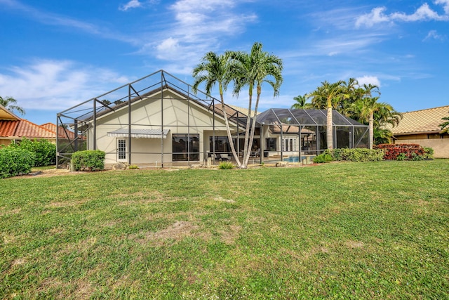 rear view of property featuring a lawn, a lanai, and a swimming pool