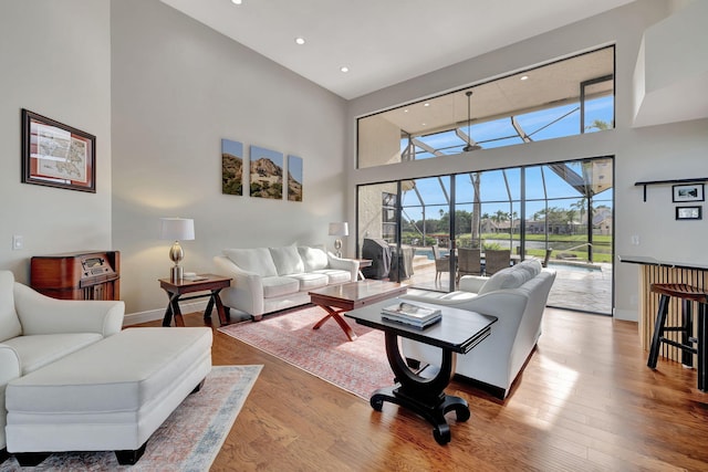 living room featuring hardwood / wood-style floors and a high ceiling