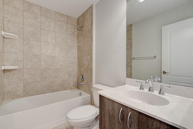 full bathroom featuring tile patterned flooring, vanity, toilet, and tiled shower / bath