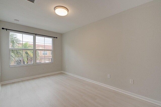 spare room with light hardwood / wood-style flooring