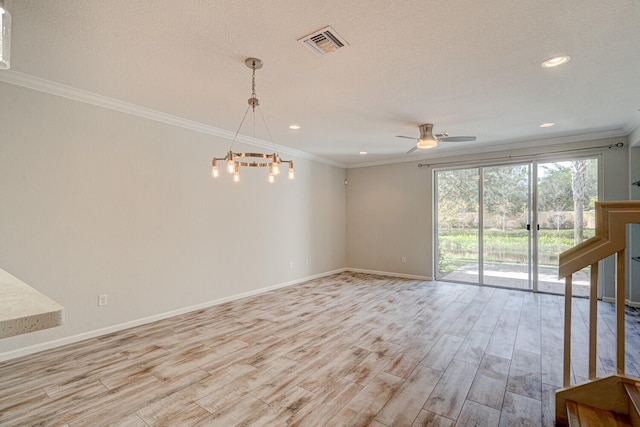 empty room with ceiling fan with notable chandelier, light hardwood / wood-style flooring, and ornamental molding