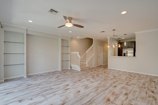 empty room featuring a textured ceiling, crown molding, light hardwood / wood-style flooring, and ceiling fan with notable chandelier