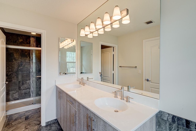 bathroom with vanity and a shower with shower door