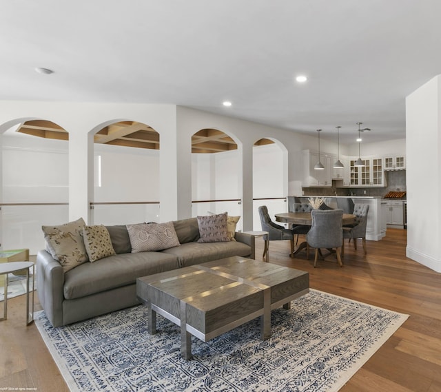 living room with wood-type flooring and beamed ceiling