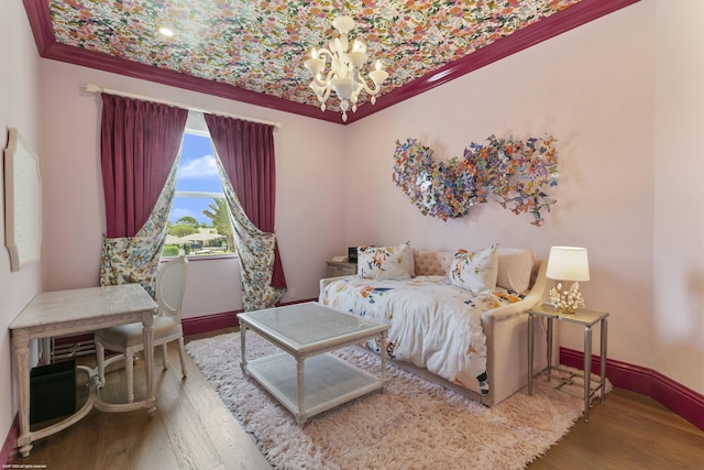 bedroom with hardwood / wood-style flooring, ornamental molding, and a chandelier