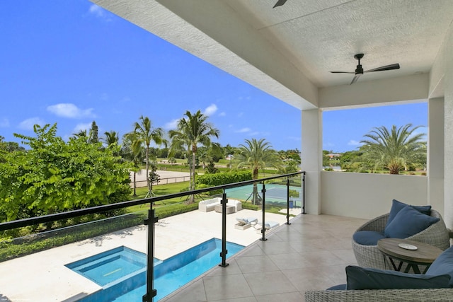 balcony featuring ceiling fan and an in ground hot tub