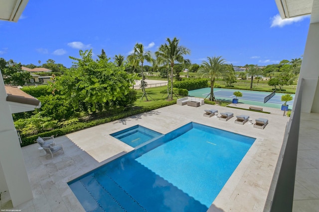 view of swimming pool featuring an in ground hot tub and a patio area