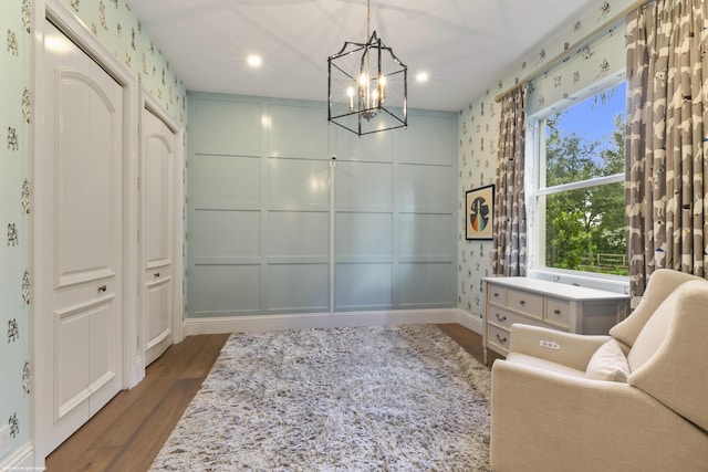 living area featuring dark wood-type flooring and a chandelier