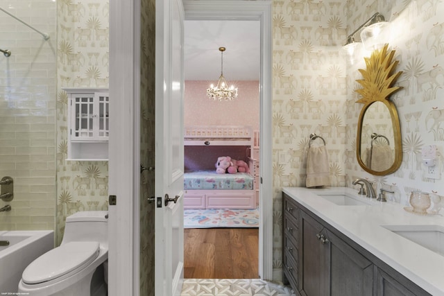 full bathroom with toilet, vanity, wood-type flooring, bathtub / shower combination, and a chandelier