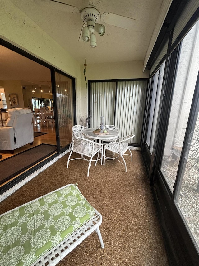 sunroom / solarium featuring ceiling fan