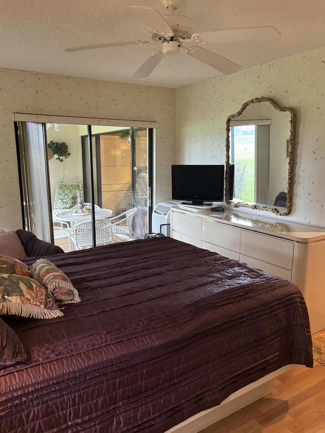 bedroom with ceiling fan, a textured ceiling, and hardwood / wood-style flooring