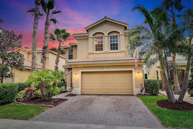 mediterranean / spanish-style house with a garage