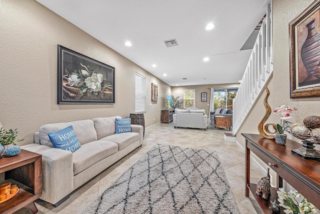 6070 SE Split Oak Trl, Hobe Sound, FL 33455 - living room with a textured wall, recessed lighting, and light tile patterned floors