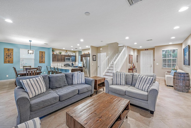 tiled living room with a textured ceiling