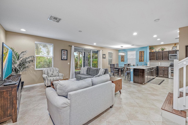 tiled living room with a wealth of natural light and sink