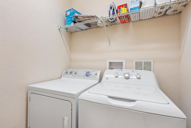 washroom with washing machine and dryer