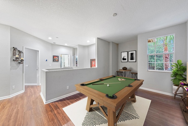 game room featuring hardwood / wood-style floors, a textured ceiling, and billiards