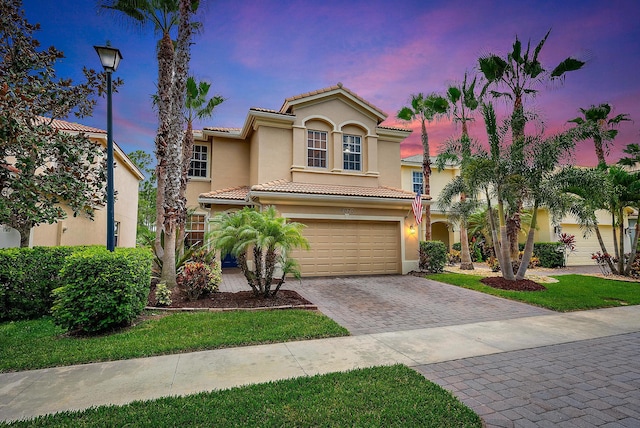 mediterranean / spanish-style home featuring a garage