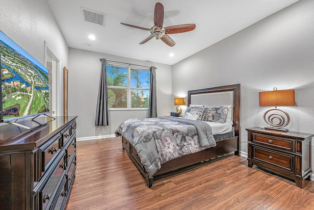 bedroom with hardwood / wood-style flooring, ceiling fan, and lofted ceiling