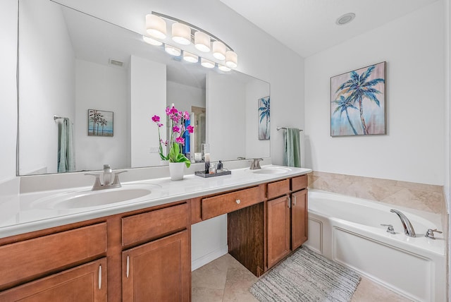 bathroom with vanity, tile patterned flooring, and a bathtub