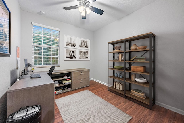 home office with a textured ceiling, ceiling fan, and dark wood-type flooring