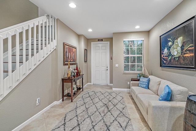 6070 SE Split Oak Trl, Hobe Sound, FL 33455 - living area featuring light tile patterned floors, a textured wall, stairway, recessed lighting, and baseboards