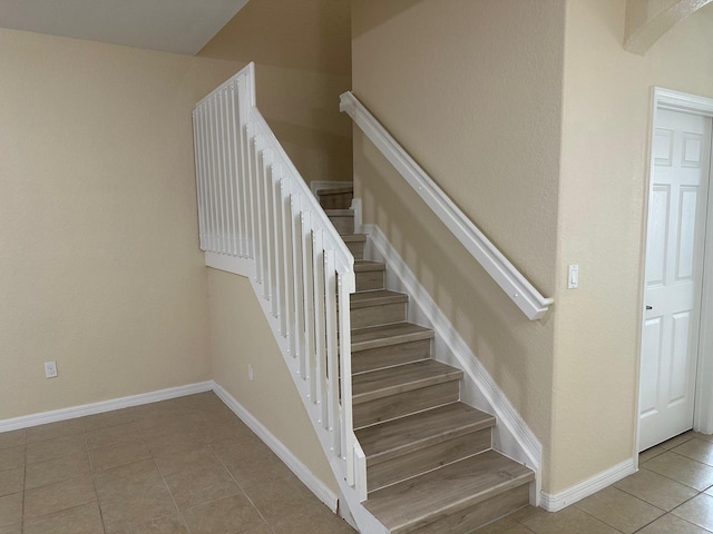 staircase with tile patterned flooring