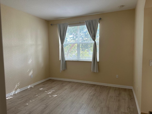 unfurnished room with light hardwood / wood-style floors