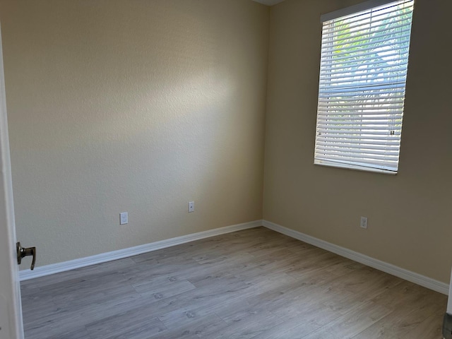 unfurnished room with light hardwood / wood-style floors