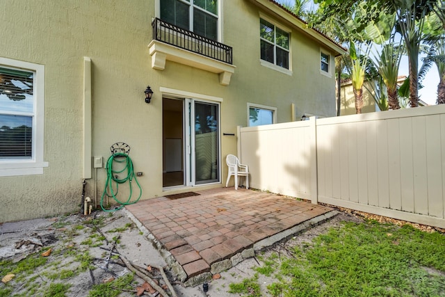 back of property with a patio area and a balcony