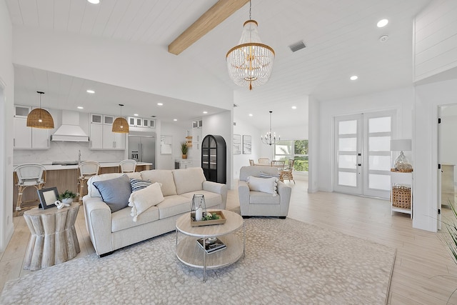 living room with french doors, light hardwood / wood-style flooring, beamed ceiling, high vaulted ceiling, and a chandelier